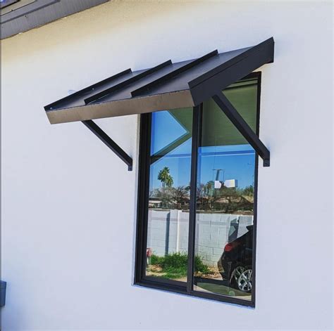 a window awning is fabricated from sheet metal|A window awning is fabricated from sheet metal with a  .